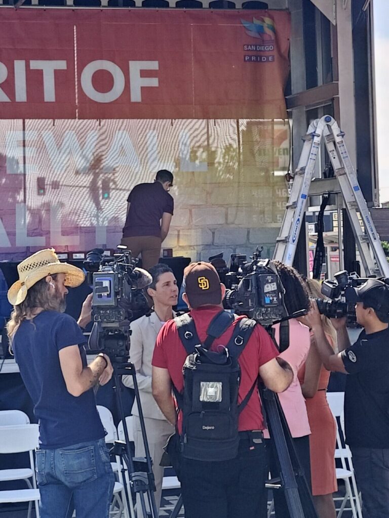 Kristin answering questions in a gaggle of reporters.